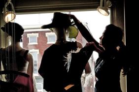 Employee Cathy Perkins tried hats on a mannequin in the window of Alter Ego in NuLu.Photo by Ron Bath